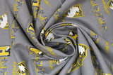 Swirled swatch licensed Harry Potter printed fabric in Hufflepuff Traits Scatter (yellow crest and text tiled on grey)