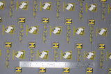 Flat swatch licensed Harry Potter printed fabric in Hufflepuff Traits Scatter (yellow crest and text tiled on grey)
