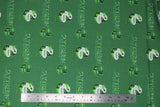 Flat swatch licensed Harry Potter printed fabric in Slytherin Traits Scatter (crest and text tiled on green)