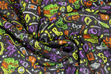 Swirled swatch artifacts toss fabric (black fabric with tiny tossed harry potter emblems/outlines drawing style in white, yellow, orange, purple, green colourway: glasses, snitch, candles, cloaks, books, etc.)
