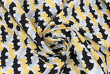 Swirled swatch licensed DC Comics printed fabric in Batman Retro Camo (tiled bat logo in black/grey/yellow on white)