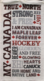 Full panel swatch My Canada Panel (46" x 24") (off white rectangular panel with large Canada related text in greys, reds, paids and buffalo checks with small red maple leaves "My Canada" etc)