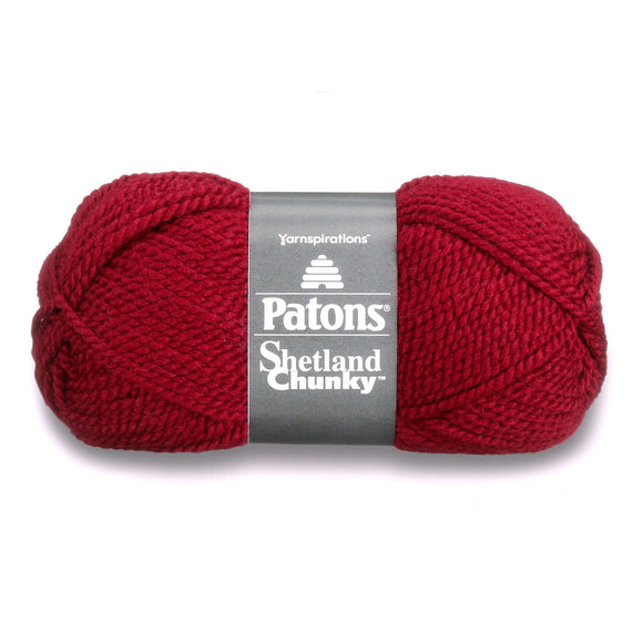 A ball of Shetland Chunky yarn in red shade on a white background