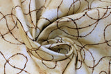 Swirled swatch Barbed Wire fabric (neutral marbled look fabric with tossed barbed wire in dark brown curling allover)