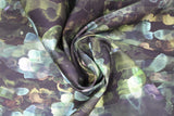 Swirled swatch assorted floral printed fabric in emerald (dark green/black fabric with watercolour look horizontal abstract lines pattern in various green and blue shades)