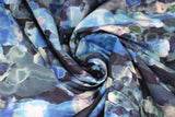 Swirled swatch assorted floral printed fabric in blue (dark blue/black fabric with watercolour look horizontal abstract lines pattern in various blue and green shades)