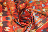 Swirled swatch bohemian printed fabric in cayenne (busy bohemian/southwest look print in reds, black, blue, yellow, white colourway)