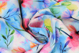 Swirled swatch spring fabric (white and blue marbled fabric with tossed pink, purple, blue, orange floral and green/black stems and greenery)