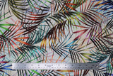 Flat swatch white fabric (white/off-white fabric with tossed this palm style leaves in various colours orange, pink, blue, green, yellow)