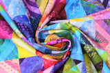 Swirled swatch Hoffman Wave: Rainbow fabric (rainbow coloured fabrics in quilt squares/patchwork design allover)