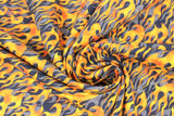 Swirled swatch fire alarm fabric (black fabric with orange/yellow flames layered over grey flames)