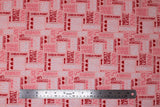 Flat swatch Love You More Than Video Games fabric (pink fabric with video game related text allover "Game over" "One up" "Combo" "Next Level" etc. in white, pink and red lettering with hearts, arrows and jewels)