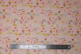 Flat swatch sophisticated spirits fabric (peach coloured fabric with tossed emblems allover orange and yellow drinks in fancy glasses, champagne bottles in pink, orange flowers, greenery, etc)