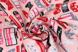 Swirled swatch Gaming Console fabric (light pink fabric with assorted cartoon style gaming controllers and consoles in grey, black, pink, white and red shades)