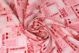 Swirled swatch Love You More Than Video Games fabric (pink fabric with video game related text allover "Game over" "One up" "Combo" "Next Level" etc. in white, pink and red lettering with hearts, arrows and jewels)