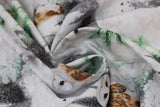 Swirled swatch light grey/silver fabric (white fabric with tossed grey forest tree lines, grey moons, white and brown barn owls, green tree sprigs, white and green floral all with a snowy look and subtle silver sparkle)