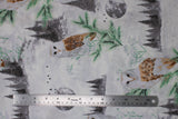 Flat swatch light grey/silver fabric (white fabric with tossed grey forest tree lines, grey moons, white and brown barn owls, green tree sprigs, white and green floral all with a snowy look and subtle silver sparkle)