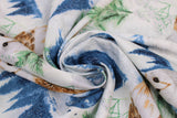 Swirled swatch dusty blue/silver fabric (white fabric with tossed blue forest tree lines, blue moons, white and brown barn owls, green tree sprigs, white and green floral all with a snowy look and subtle silver sparkle)
