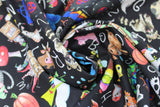 Swirled swatch Alphabet Soup fabric (black fabric with tossed full colour cartoon/illustrative style zoo animals, floral, etc. with tossed white alphabet letters allover)