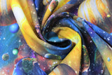 Swirled swatch Artworks XVIII fabric (busy multi coloured galaxy printed fabric with tossed planets and stars all in bright colours)