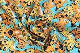 Swirled swatch Stacked Tigers fabric (light teal fabric with busy stacked/tossed cartoon style baby tigers allover)