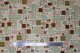 Flat swatch Words fabric (white fabric with multi directional text allover in red and green with gold metallic accents and tossed christmas themed badges, text is: "Holy Night" "Rejoice" "Noel" etc)