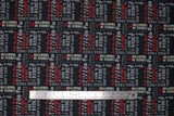 Flat swatch Biker Life fabric (charcoal grey fabric with white and red biker related text allover in various directions and fonts)