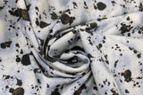 Swirled swatch Grease fabric (white/grey marbled look fabric with black grease stains allover)