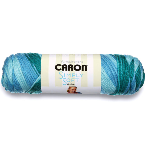 A ball of Caron Simply Soft Ombre yarn in light to dark blues/turquoise colourway
