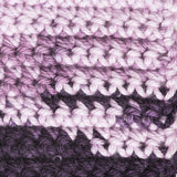 Woven yarn in grape purple displaying the effect of the ombre yarn when blended together