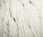 Swatch of Caron Simply Soft Tweeds yarn in white shade with brown tweed flecks