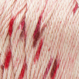Swatch of Caron Simply Soft Speckle yarn in shade chili flakes (palest pink yarn with medium and dark pink speckles)