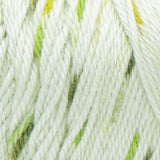 Swatch of Caron Simply Soft Speckle yarn in shade chlorophyll (white/palest green yarn with light and dark green speckles) 