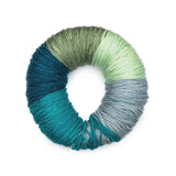 Caron Colorama round shaped yarn in colourway Baja (deep teal, pale hunter green, mint, baby blue, teal)