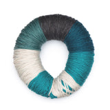 Caron Colorama round shaped yarn in colourway Blue Mustang (cream, faded teal, pale navy, medium teal, bright teal)