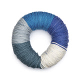 Caron Colorama round shaped yarn in colourway Overboard (pale blue grey, medium bright blue, dark bright blue, cream, pale deep blue)