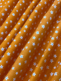 Swirled swatch microprint flannel in dainty flowers on orange (white tiny flower heads)