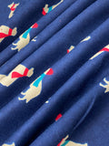Swirled swatch winter themed flannel in Winter dogs (white dogs with red and blue scarves and hats on dark blue)