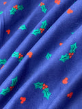 Swirled swatch winter themed flannel in Mistletoe on blue (tiny hollies on medium blue)