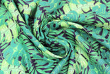 Swirled swatch tropical fabric in big leaves (black fabric with large layered leaves in various greens and styles)