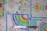 Flat swatch learn to grow fabric (white and pale grey fabric with colourful stamp outline look patches in blue shades decorated with rainbows, coloured hearts, flowers and clouds with smiley faces, "Learn and Grow" text)
