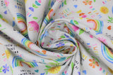 Swirled swatch sweet dreams fabric (white fabric with small tossed colourful emblems allover: rainbows, hearts, flowers, "Sweet dreams" text, "Learn and grow" text, etc.)