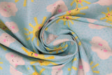 Swirled swatch partly cloudy fabric (pale blue fabric with tossed smiling yellow suns and white clouds with pink rosy cheeks)