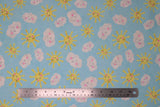 Flat swatch partly cloudy fabric (pale blue fabric with tossed smiling yellow suns and white clouds with pink rosy cheeks)