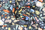 Swirled swatch Strawberry Fields collection floral printed fabric in black meadow (multi-coloured floral and strawberries on black)