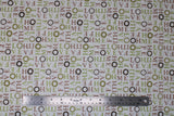 Flat swatch Home Love fabric (white fabric with multi-directional words allover in beige and green saying "HOME" "HOPE" "LOVE" etc., some circular leafy wreaths in green and brown)