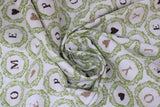 Swirled swatch Love Wreath fabric (white fabric with small circular green leafy wreaths allover with single letters inside in black and beige creating words "HOME" "JOY" "LOVE" "HOPE", some wreaths have black or beige hearts)