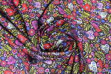 Swirled swatch paisley hearts fabric (busy tossed paisley printed small hearts and deconstructed paisley pattern elements, swoops and floral tossed allover black fabric in red, purple, yellow, blue, cream colourway)