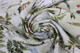 Swirled swatch forest themed fabric in Bird Notes (plants, bugs, birds vintage look collage on white)