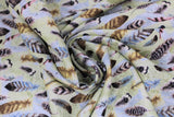 Swirled swatch forest themed fabric in Feathers (multi neutral shade feathers on blue/white)